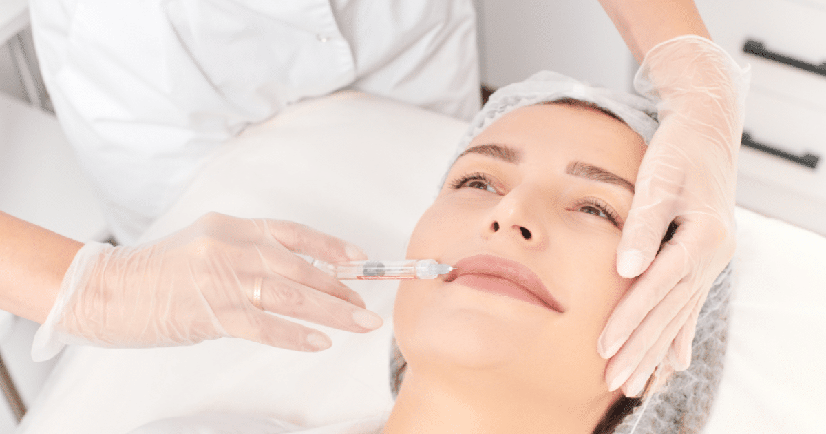 a woman undergoing lip filler treatment