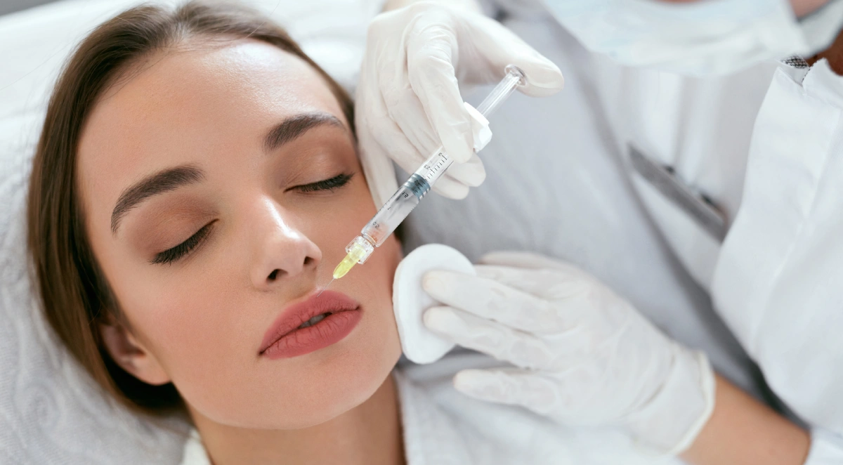 someone injecting lip filler